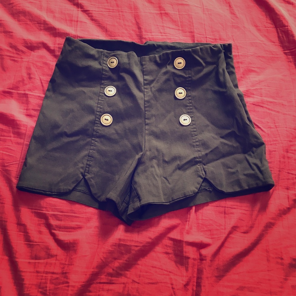 Green high waisted shorts with gold buttons